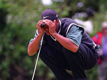 Tiger Woods focusing on a putt